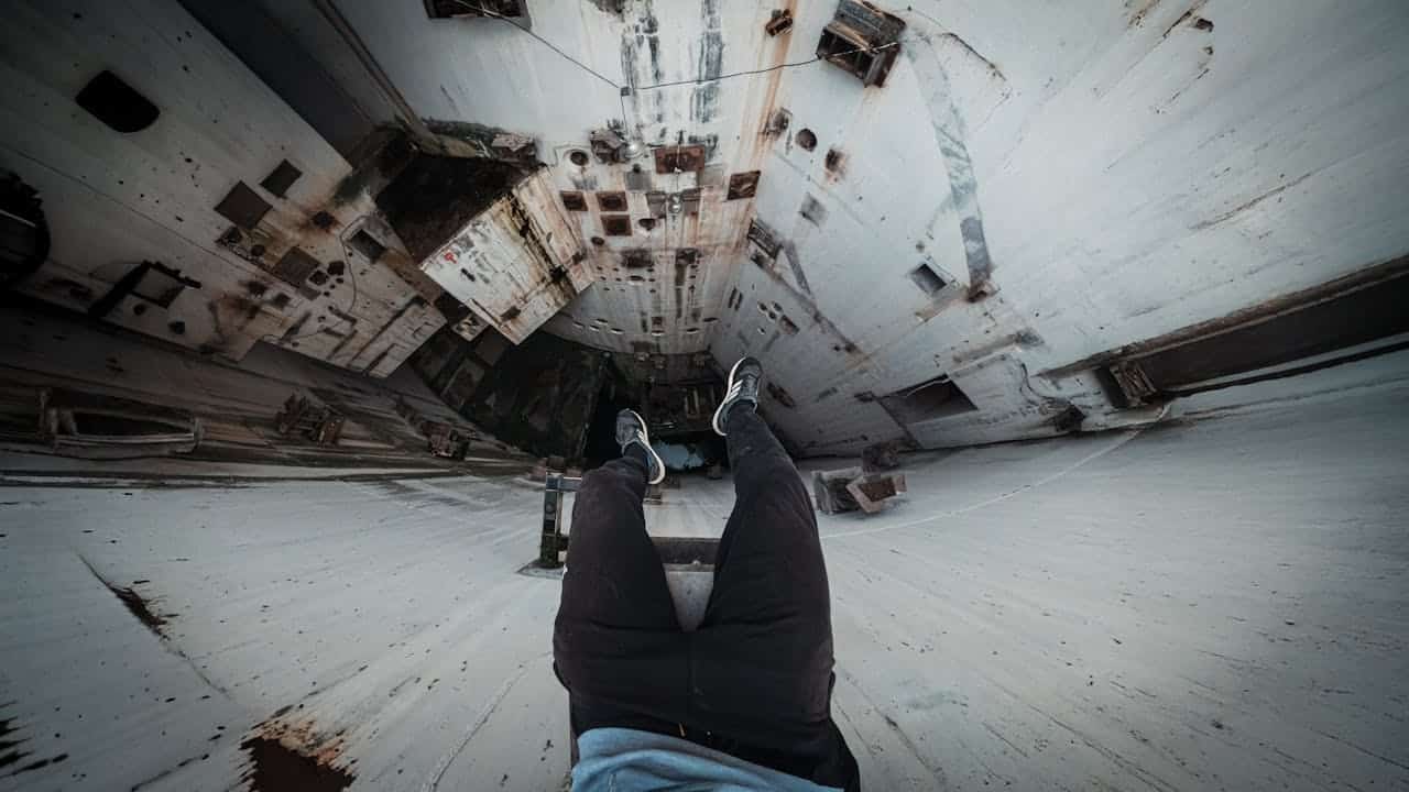 Person standing at the edge of a deep structure, symbolizing depth-oriented therapy and exploring the unconscious mind